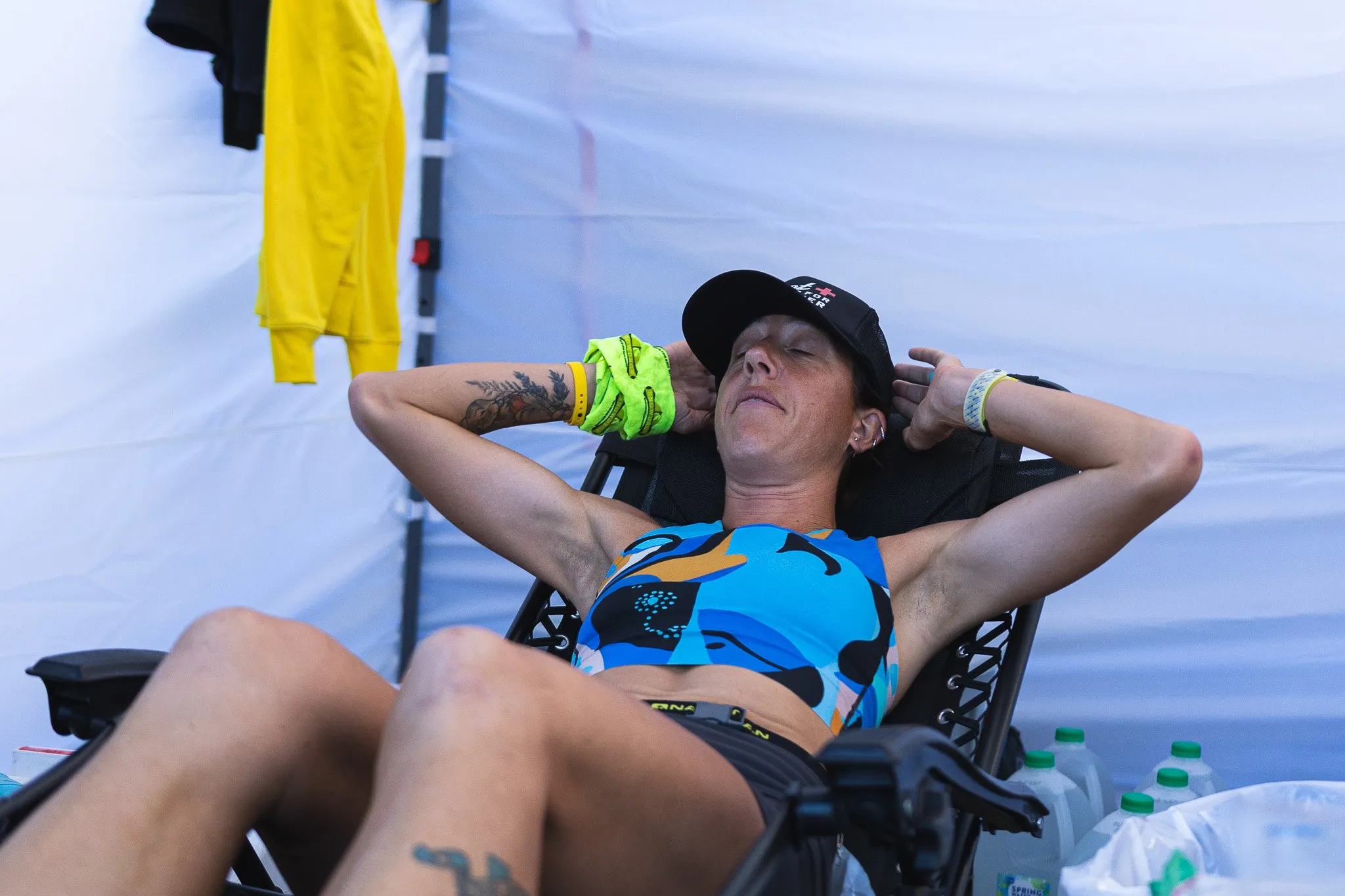 Megan Eckert resting in a camp chair between loops at Big’s Backyard Ultra