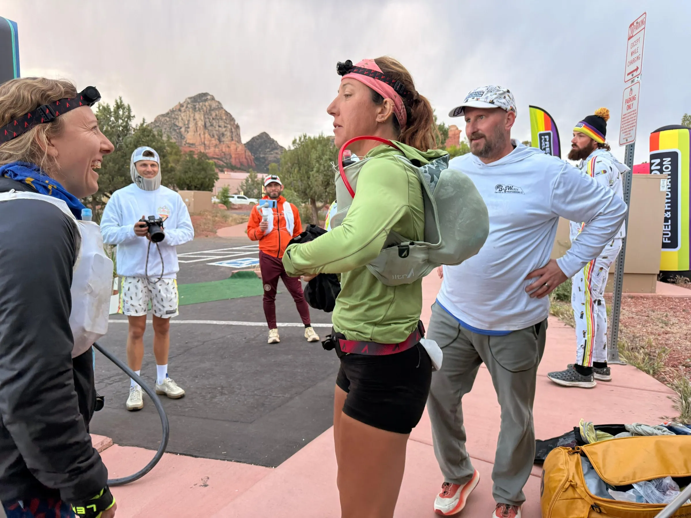 Megan Eckert at an aid station in Arizona with crew and red rock behind