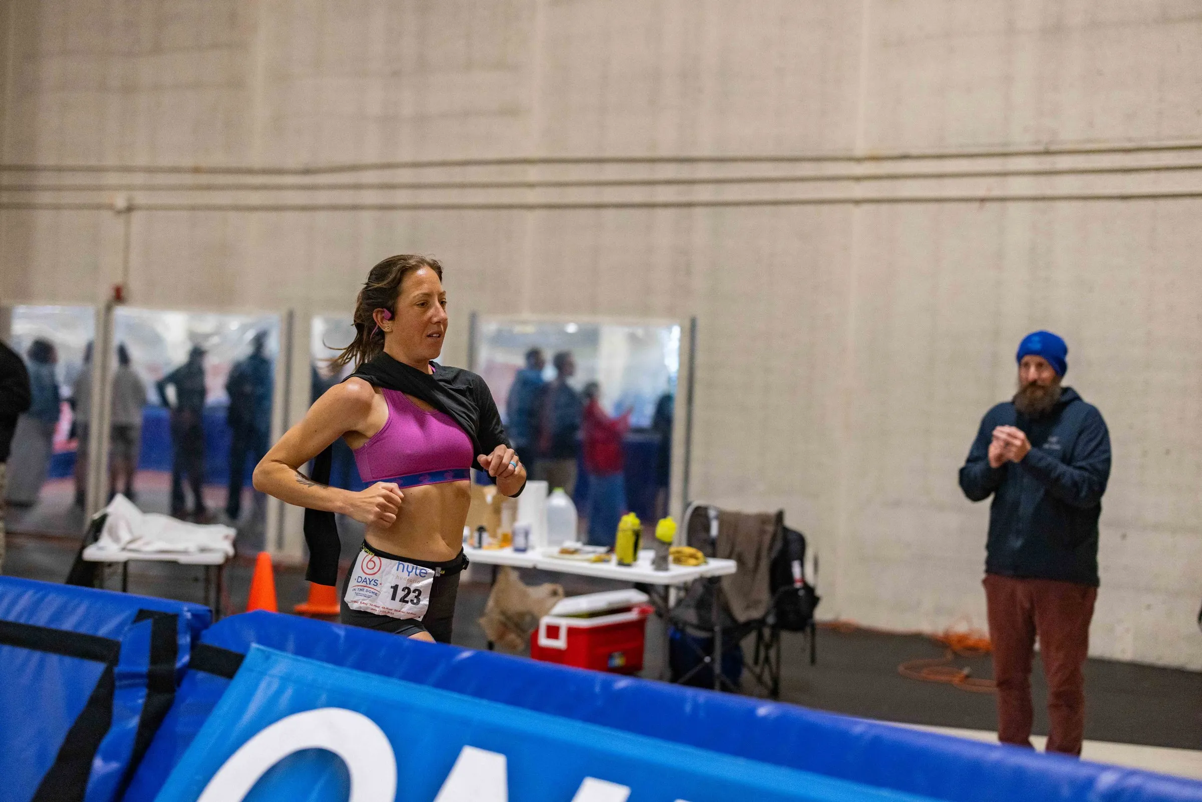 Megan Eckert running inside an indoor track dome during a six-day race